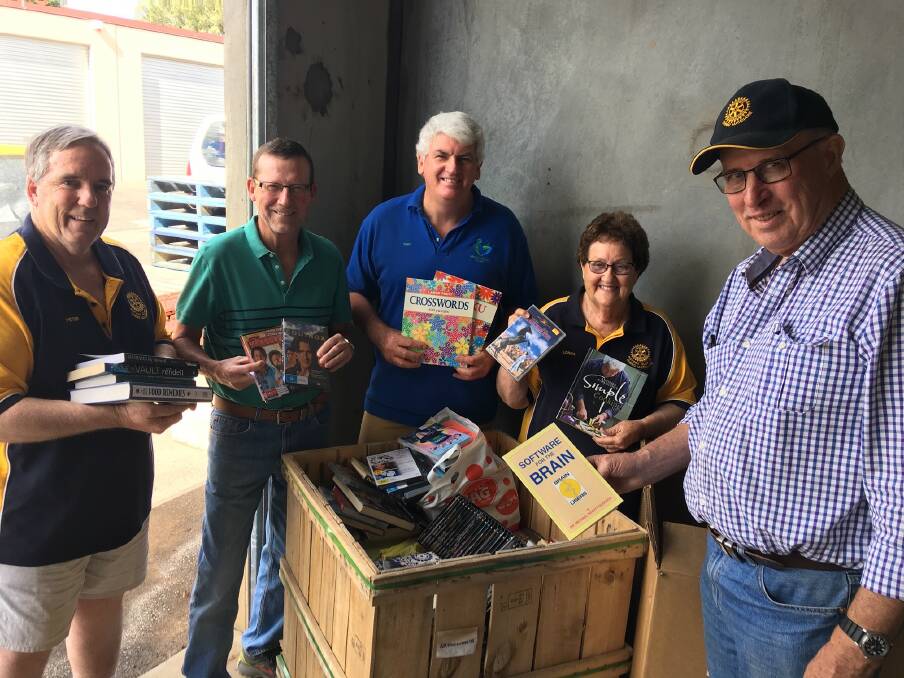 WORKING BEE: Rotary Club of Dubbo Macquarie's Peter Bartley, Garry Brown, Peter English, Lorna Breeze and Lawrie Donoghue get ready for its first Michael Egan Memorial Book Fair working bee for the year on January 31. Photo: Contributed