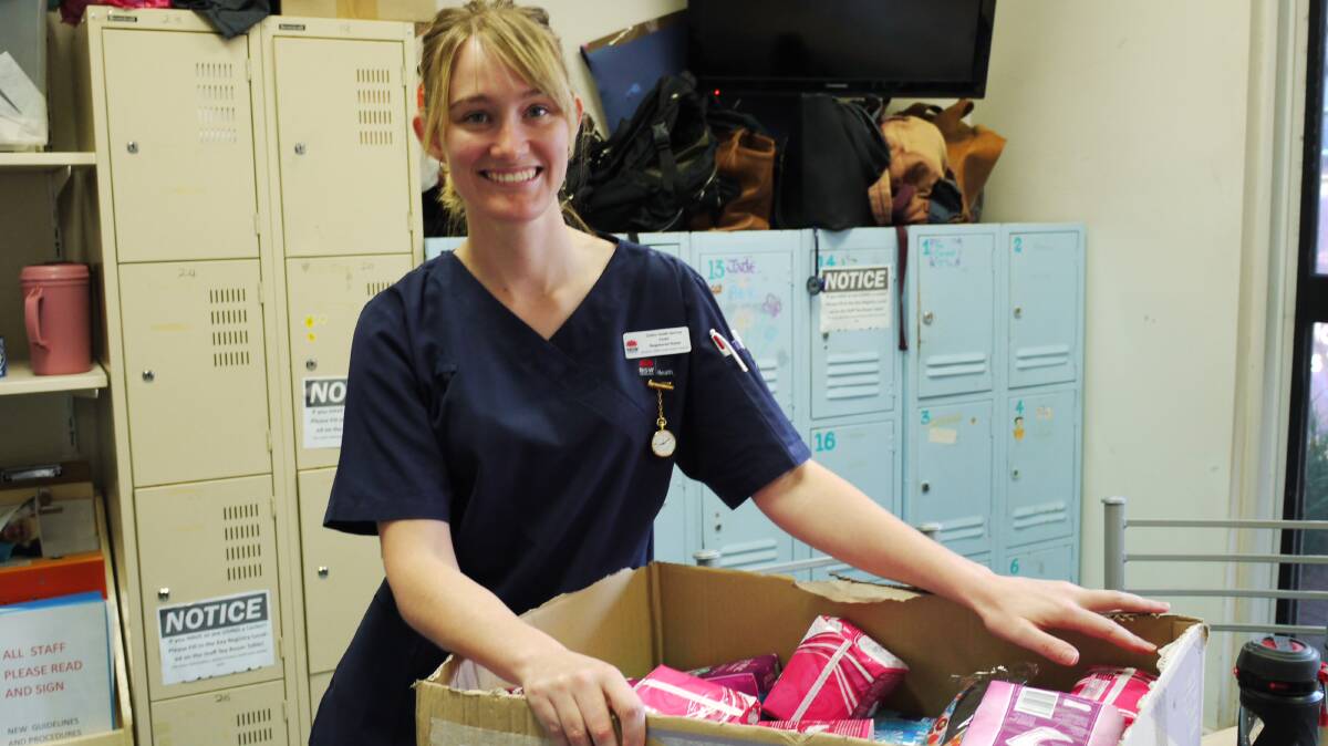 DIGNITY:  Dubbo Hospital Emergency Department registered nurse Emilie Taylor inspects donated sanitary products for Share the Dignity. Photo: KIM BARTLEY.   