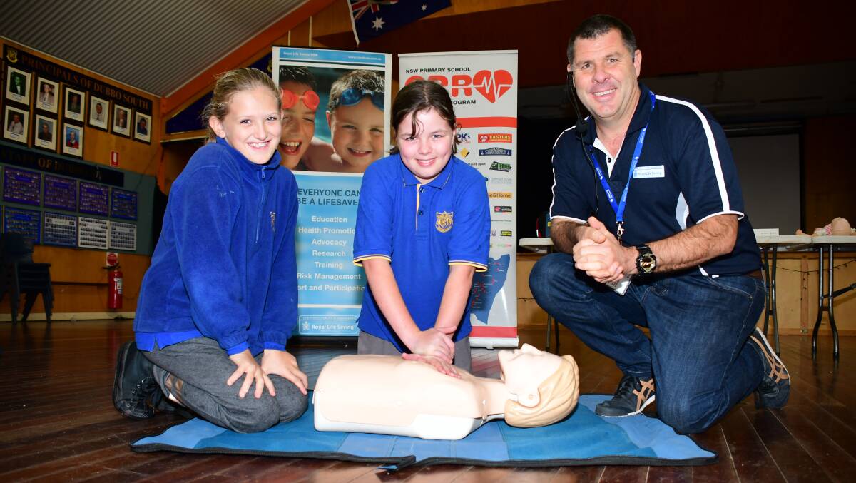 LESSON: Dubbo South Public School students Ebony Herd and Adelaide Cowper learn CPR from Cameron McFarlane. Photo: BELINDA SOOLE