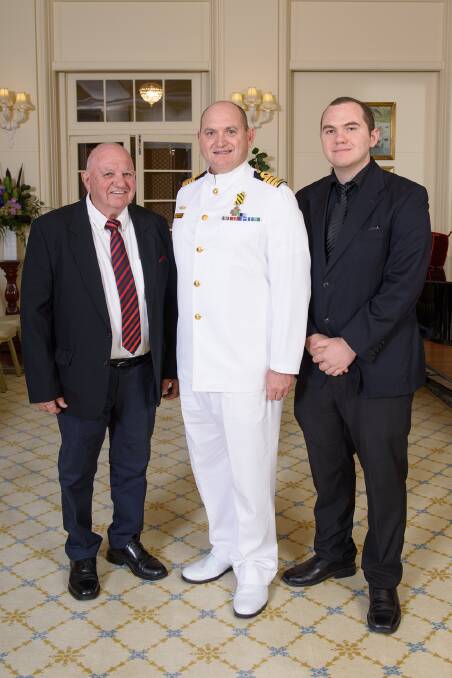 CONGRATULATIONS: Captain Anthony Klenthis is congratulated by his father George and son Allister after receiving the Conspicuous Service Cross. Photo: Contributed