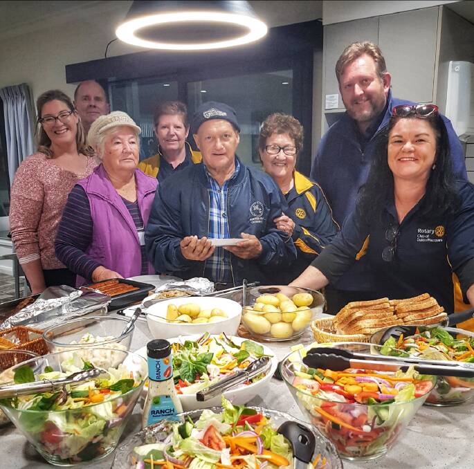 DELICIOUS: Lorna Breeze (third from right) Rod Crowfoot and Jen Cowley help Macquarie Home Stay guests from Lightning Ridge at a dinner prepared by the Rotary Club of Dubbo Macquarie. Photo: Contributed
