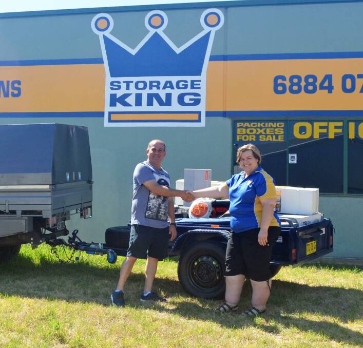 WINNER: Louis Nakad is congratulated on winning the trailer raffle by the president of the Rotary Club of Dubbo West Nicole Shanks. Photo: Contributed.