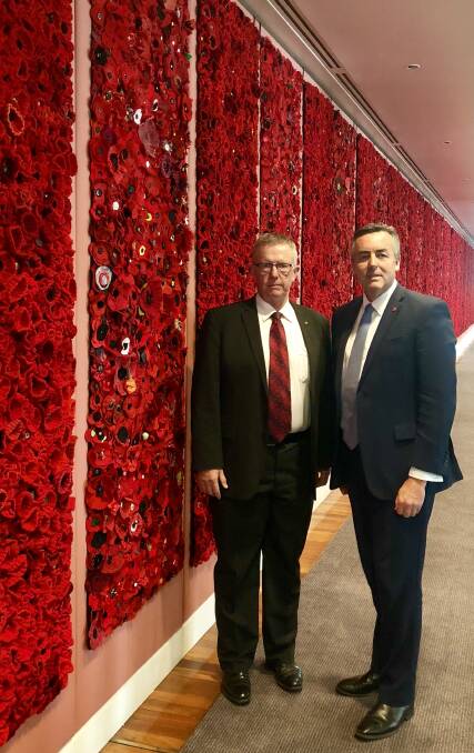 POPPIES: Member for Parkes Mark Coulton joins Minister for Veterans’ Affairs Darren Chester at a special installation of handcrafted red poppies in the marble foyer at Parliament House to commemorate the Centenary of Armistice. Photo: Contributed