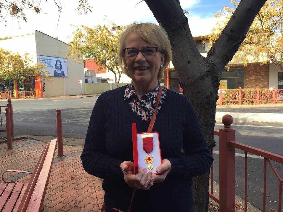 OUTSTANDING: Tomingley's Sue Strahorn holds her Australian Red Cross outstanding service award. Photo: CRAIG THOMSON
