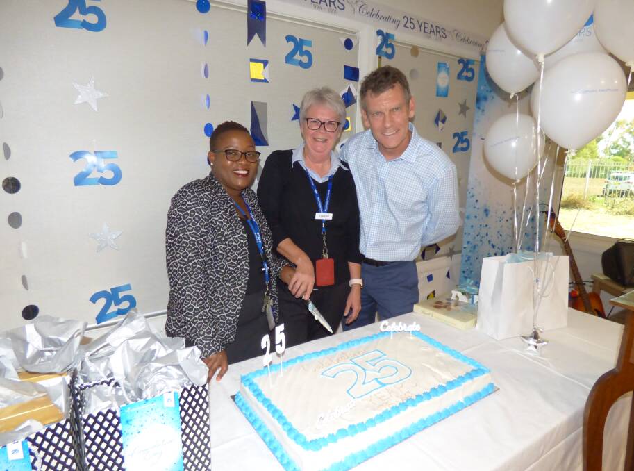 CELEBRATION: Holy Spirit Dubbo's acting residential manager Annie Chida, acting clinical manager Terese James and Catholic Healthcare managing director David Maher cut the anniversary cake. Photo: KIM BARTLEY