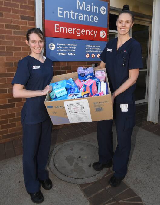 DIGNITY DRIVE: Emilie Taylor and Michelle Regan carry the donations made by Dubbo Hospital Emergency Department staff to not-for-profit Share the Dignity's dignity drive this August. Photo: BELINDA SOOLE