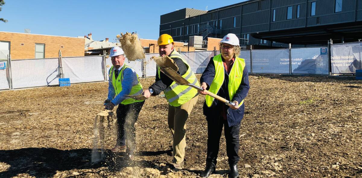 UP AND AWAY: Member for the Dubbo electorate Dugald Saunders, Hansen Yuncken project manager Daniel Spirit-Jones and Dubbo Hospital general manager Debbie Bickerton turn the ceremonial sod on the $30 million car park project. Photo: KIM BARTLEY.