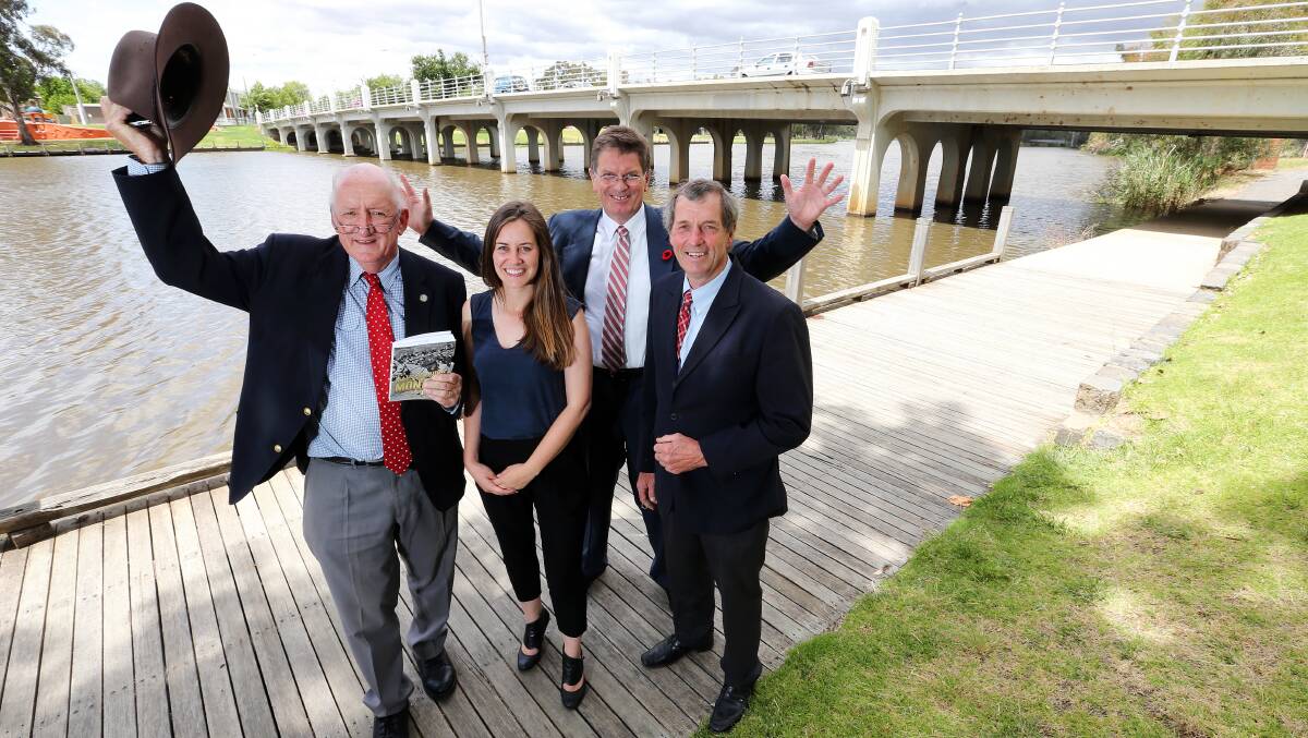 Salute to great Australian: Tim Fischer with his biography of John Monash which he launched at Benalla with the support of MPs past and present Steph Ryan, Ted Baillieu and Bill Sykes. They are standing in front of bridge designed by the World War I general during his time as an engineer.