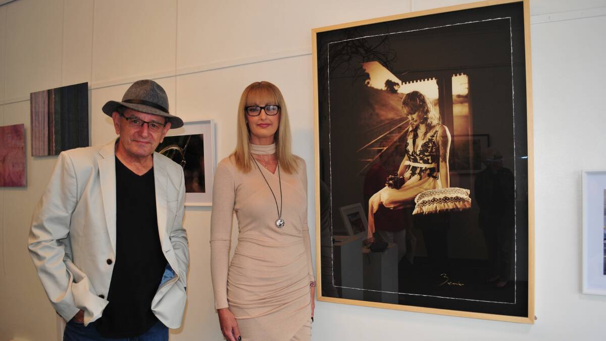 ARTIST AND HIS MUSE: Photographer Zenio Lapka, with model Michelle-Thomson McLeod, standing with Zenio's portrait of her, at the exhibition.
