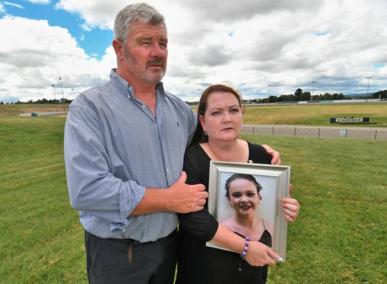 ADVOCATING FOR ALL CHILDREN: Tilly's parents, Murray Rosewarne and Emma Mason, holding a photo of Tilly. Photo: CHRIS SEABROOK.