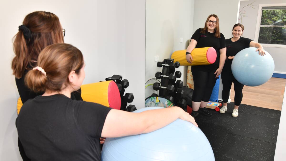 Courtney Johnson and Eden Bradford from Canobolas Kids Physio helped young Ted Johnston walk independently for the first time. Picture by Jude Keogh.