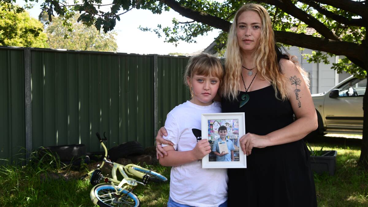 Isabella and Katrina Hayward holding a photo of Decklan Hayward who died after choking on food at school. He was seven years old. Picture by Carla Freedman