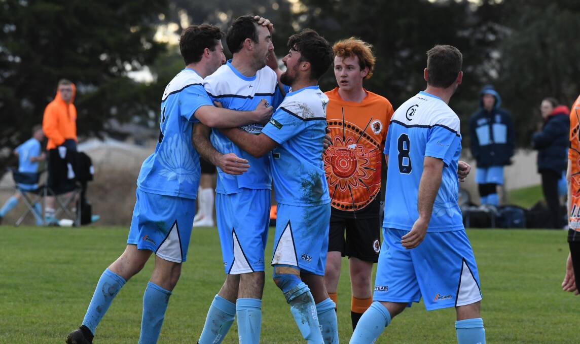 SPECIAL: Dubbo FC's Kane Settree can only watch on as Guy Burgess is mobbed by teammates after scoring for Waratahs on Saturday. Photo: JUDE KEOGH.
