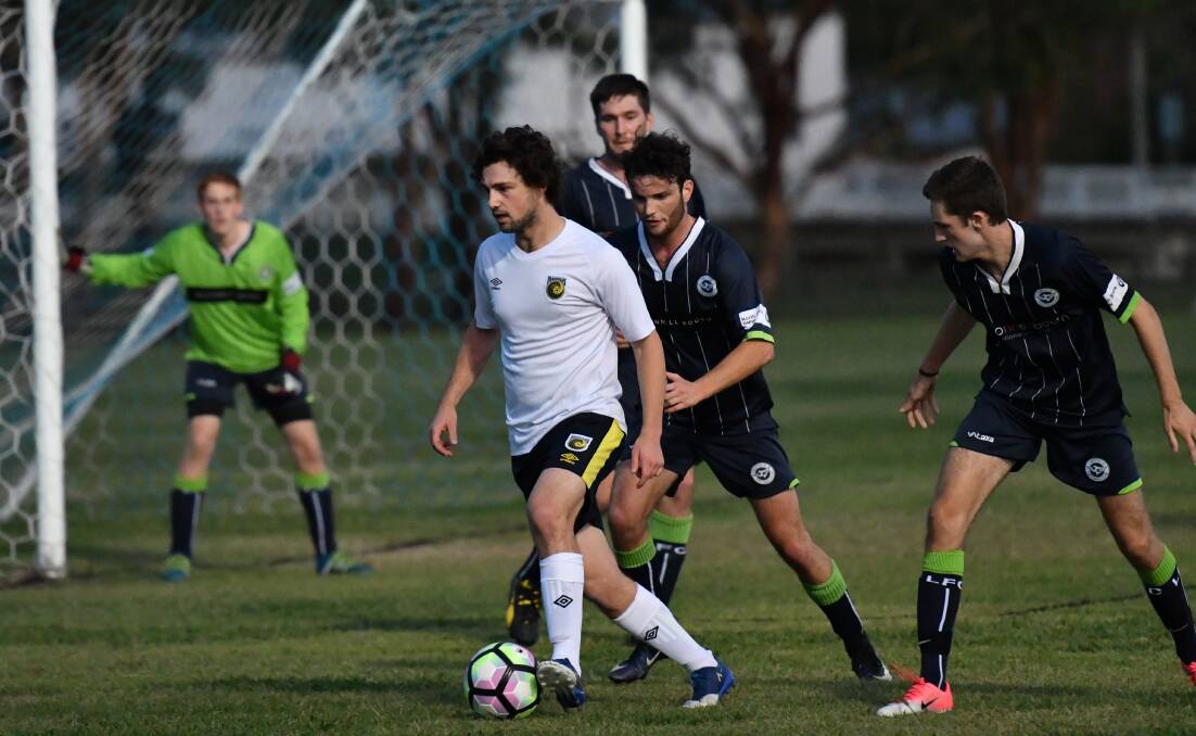 CLOSE DEFEAT: Josh Ward, pictured in last season's FFA Cup game against Lindfield, and Western NSW Mariners FC went down to the Wagga City Wanderers on Sunday. Photo: ALEXANDER GRANT