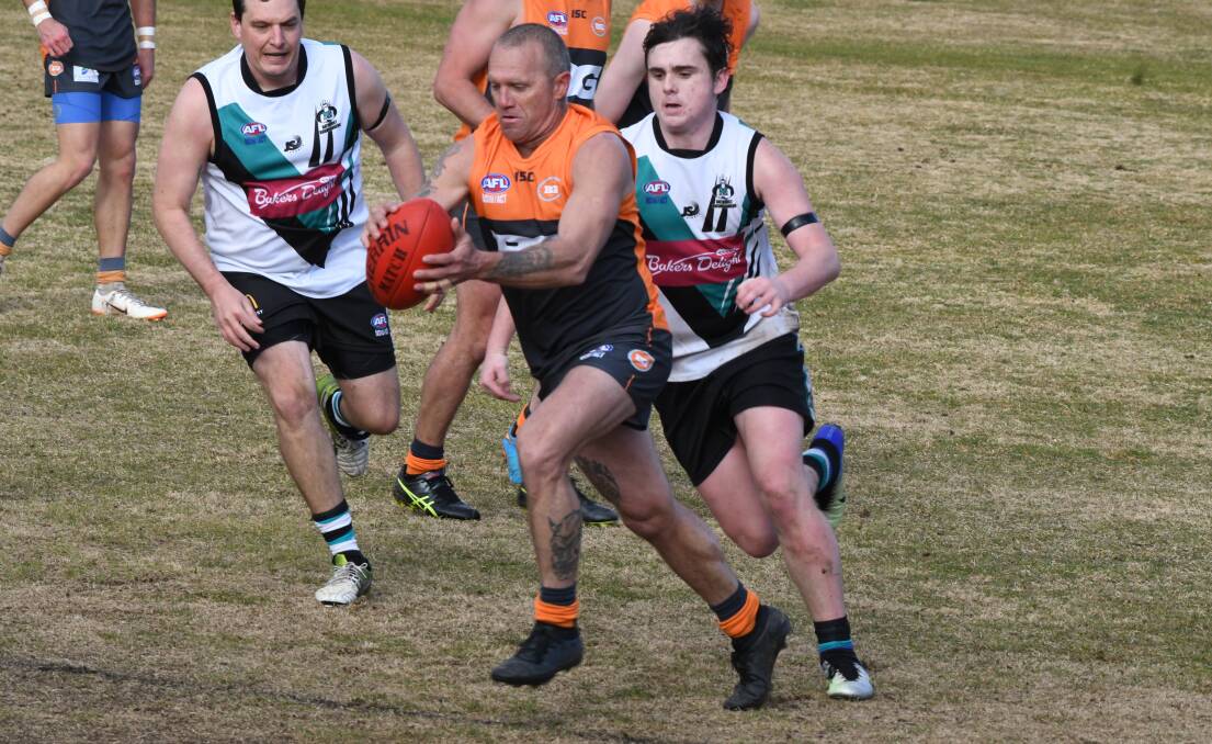 WINDING UP: Bathurst Giants' Damian Cuff prepares to boot the ball to safety during last round's match against the Bathurst Bushrangers Rebels. Photo: CHRIS SEABROOK