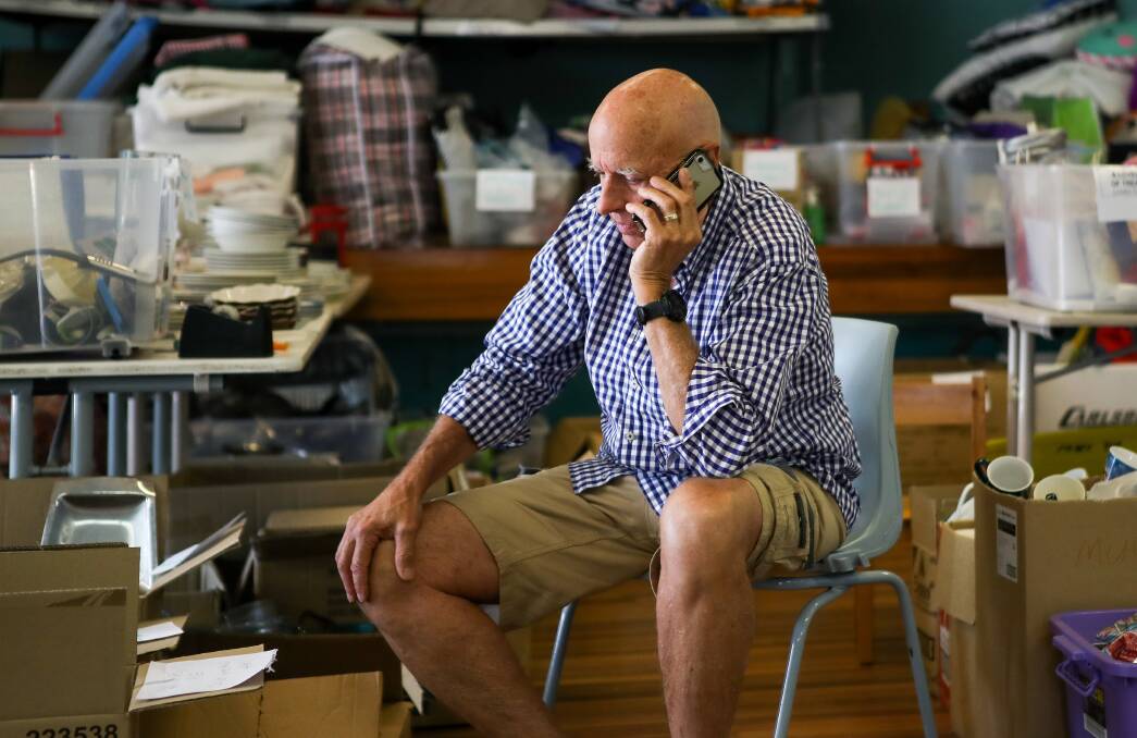 Former ESA boss Peter Dunn works the phones at the bushfire relief centre in Lake Conjola, on the NSW South Coast, last summer. Picture: Adam McLean