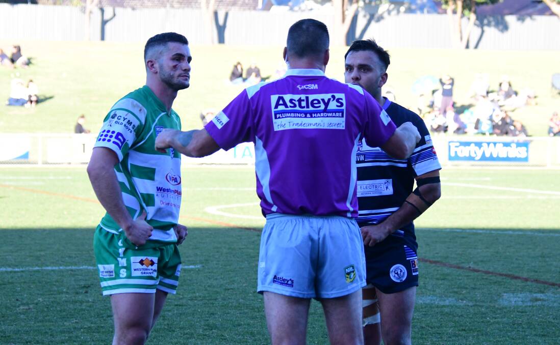 TENSION: Jarryn Powyer (left) and Alex Ronayne speak with referee Simon Hartas during Sunday's match. Photo: NICK GUTHRIE