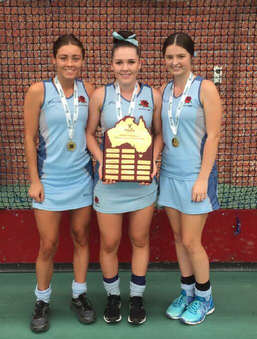 GOLDEN GIRLS: Dubbo players Phoebe Bloink Hollier, Emma Corcoran and Courtney Hogan with the Hockey Australia trophy. Photo: FACEBOOK