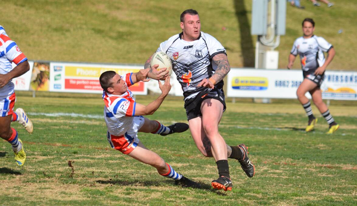 GO AGAIN: Forbes' Tim Dukes in action against Parkes last season. The clubs are unlikely to play in a western league but could do battle against each other. Photo: NICK GUTHRIE
