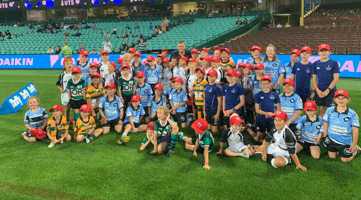 TOGETHER AGAIN: Western Plains juniors together with Dubbo product and Waratahs player Tom Robertson (back, centre) at a Super Rugby game early this year. Photo: FACEBOOK