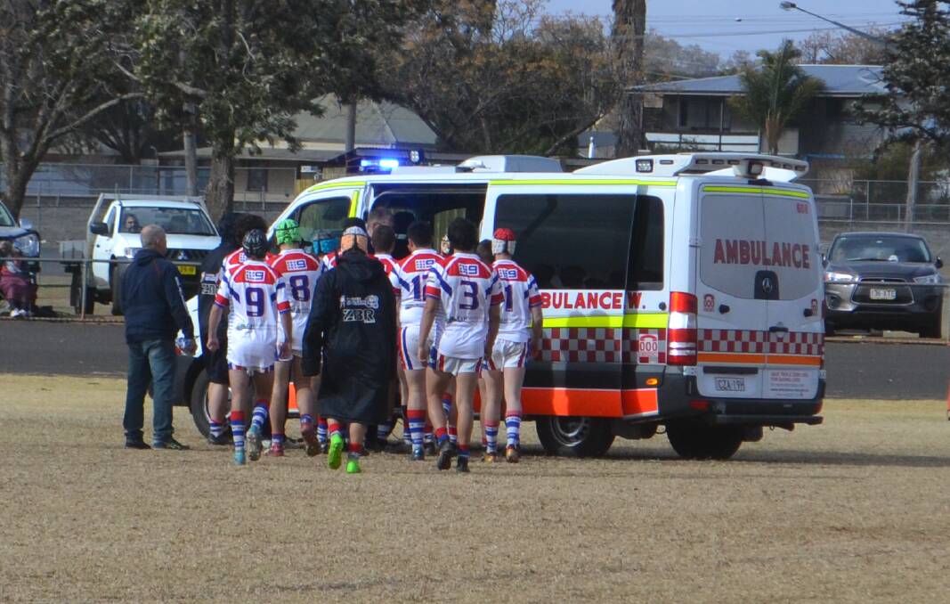 WELL WISHES: Parkes Spacemen under 18s players gathered around Will Press after his injury at Wellington on Sunday. Photo: NICK GUTHRIE