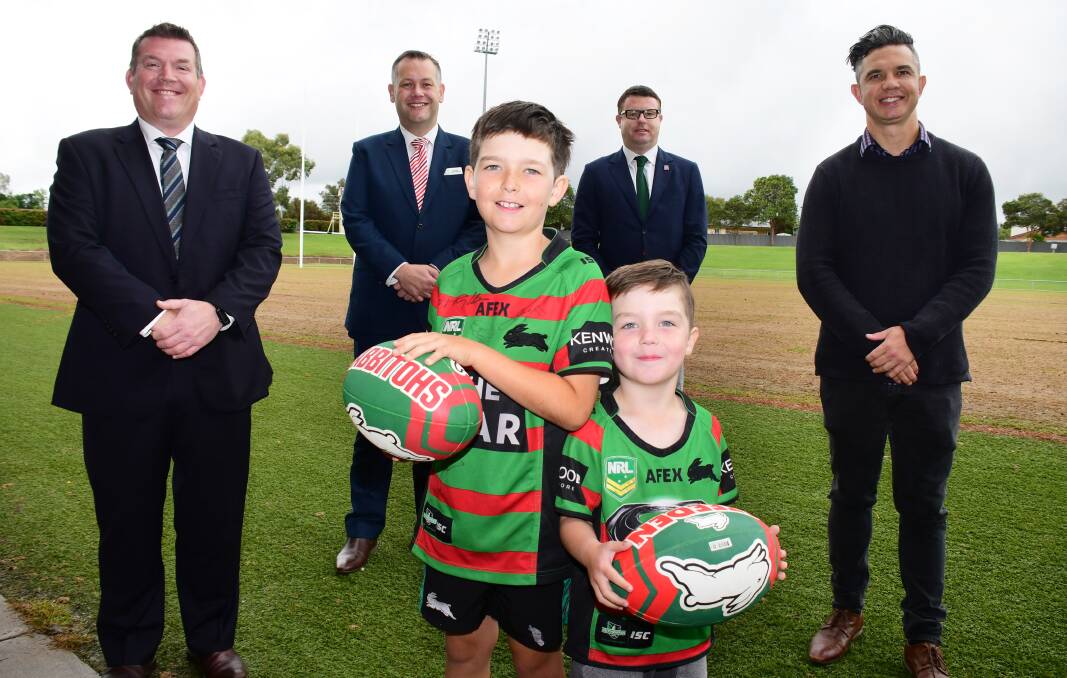 RED AND GREEN: Dubbo MP Dugald Saunders, mayor of Dubbo Regional Council Ben Shields, Rabbitohs CEO Blake Solly, and former Souths player Joe Williams with (front) fans Lawson and Spencer Marchant. Photo: BELINDA SOOLE
