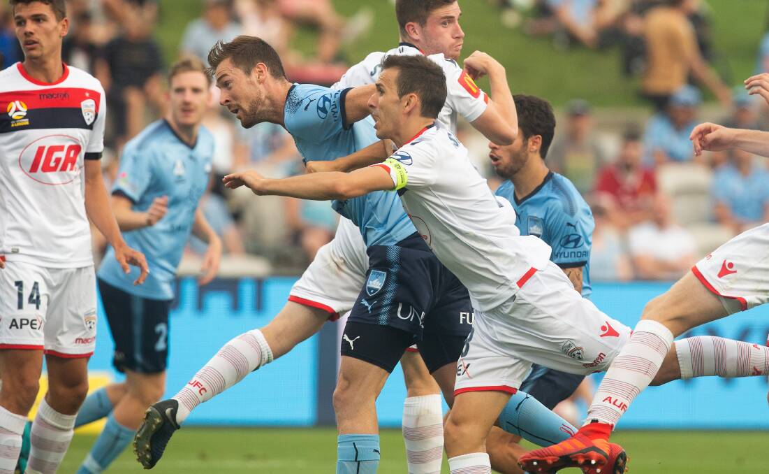 GO FOR IT: Jacob Tratt, pictured battling for a header earlier in the season, is in the running for a starting spot at a key time of the season for Sydney FC. Photo: AAP/STEVE CHRISTO