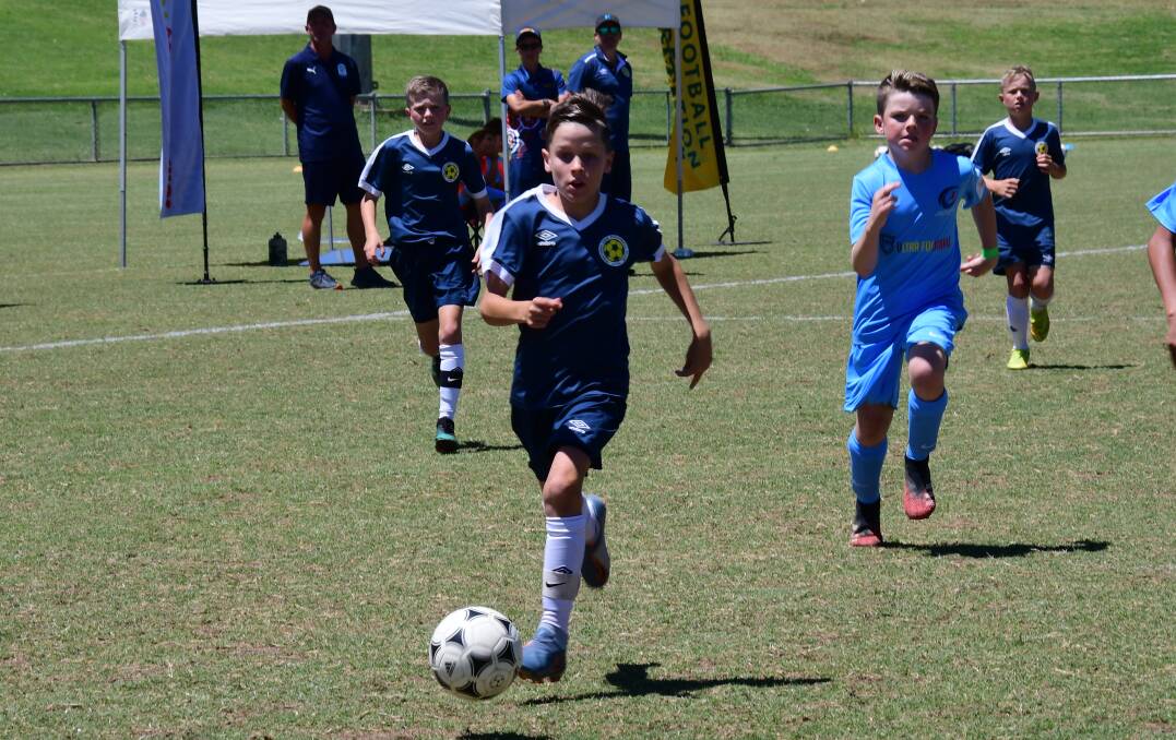 TALENT ON SHOW: Dubbo's Fynn Auld of the Western NSW under 11s is chased by Nayte Ramien during one of the many gala day matches at Apex Oval on Saturday. Photos: BELINDA SOOLE