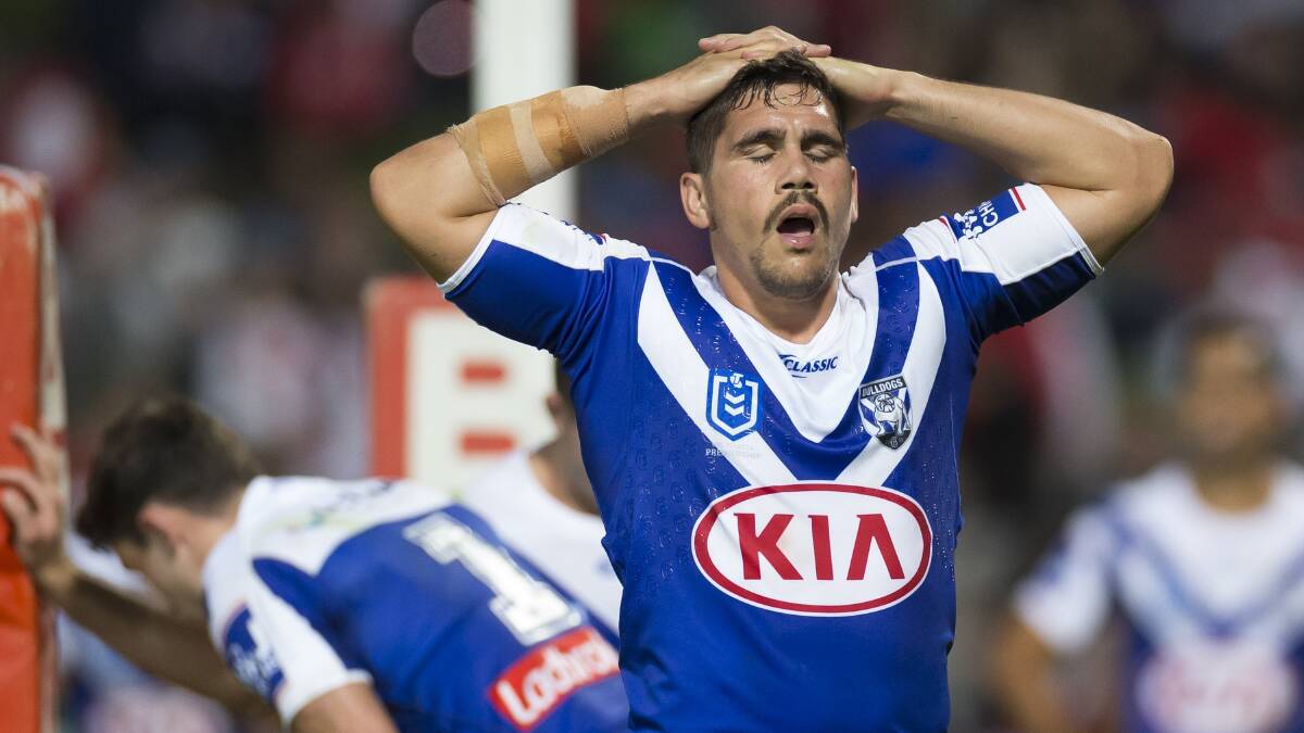 STRUGGLES: Chris Smith shows what it felt like to be a Bulldogs player during Sunday's heavy loss. Photo: AAP