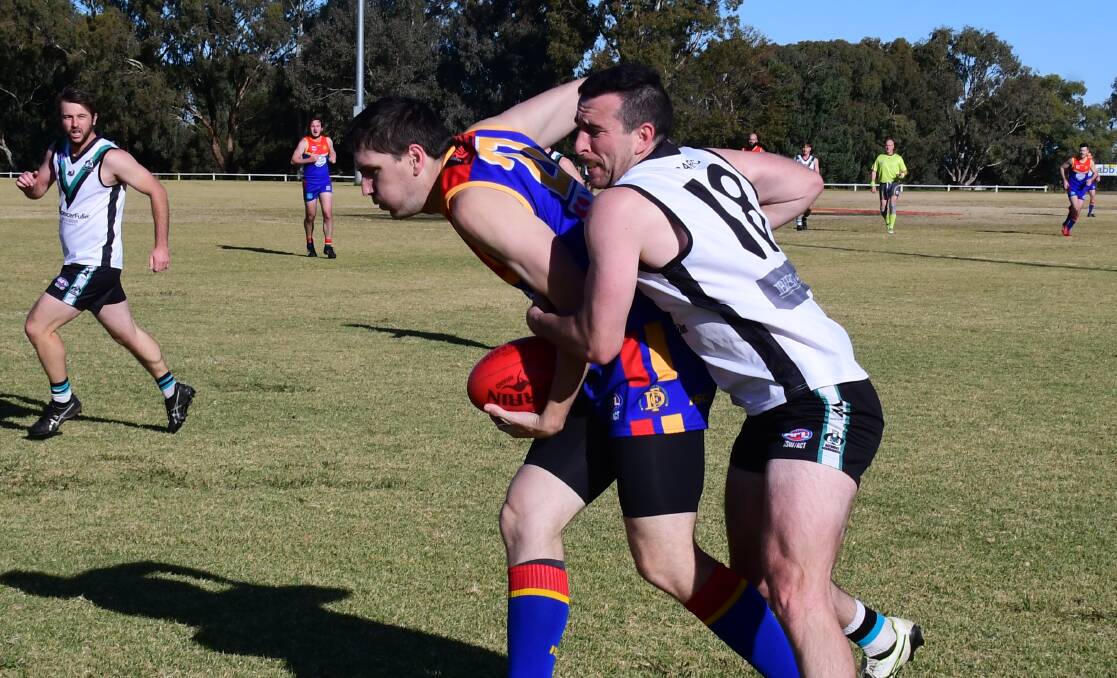 BATTLE: Josh Anasis of the Dubbo Demons attempts to break free of a Nathan Swards tackle during a clash with the Bushrangers last season. Picture: Amy McIntyre