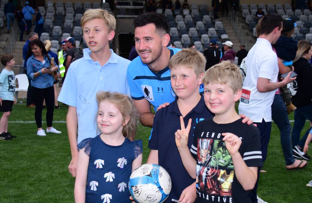 GOOD TIME: Sydney FC defender Ryan McGowan spent a huge amount of time posing for photos and signing autographs at Apex Oval. Photo: AMY McINTYRE