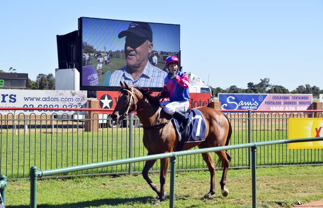 UNFORGETTABLE: Jake Pracey-Holmes celebrates aboard Stoneyrise while James Hatch speaks about the win on the big screen. Photo: BELINDA SOOLE