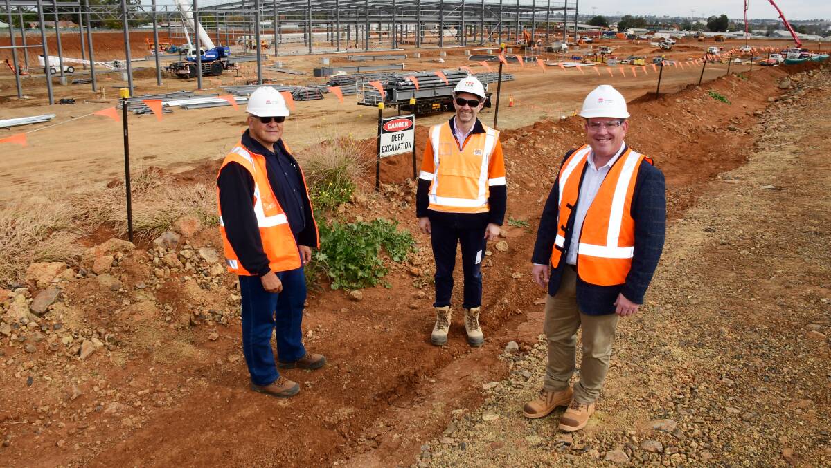 Dugald Saunders (right) with Transport for NSW's John Peric and project director Nick Fryday at the maintenance facility construction site last year. Picture by Belinda Soole