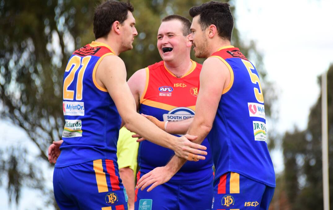 BREAKTHROUGH: Dylan Fairall (centre), pictured celebrating a previous win at home, kicked a goal in the Demons' drought-breaking win on Saturday. Photo: AMY McINTYRE