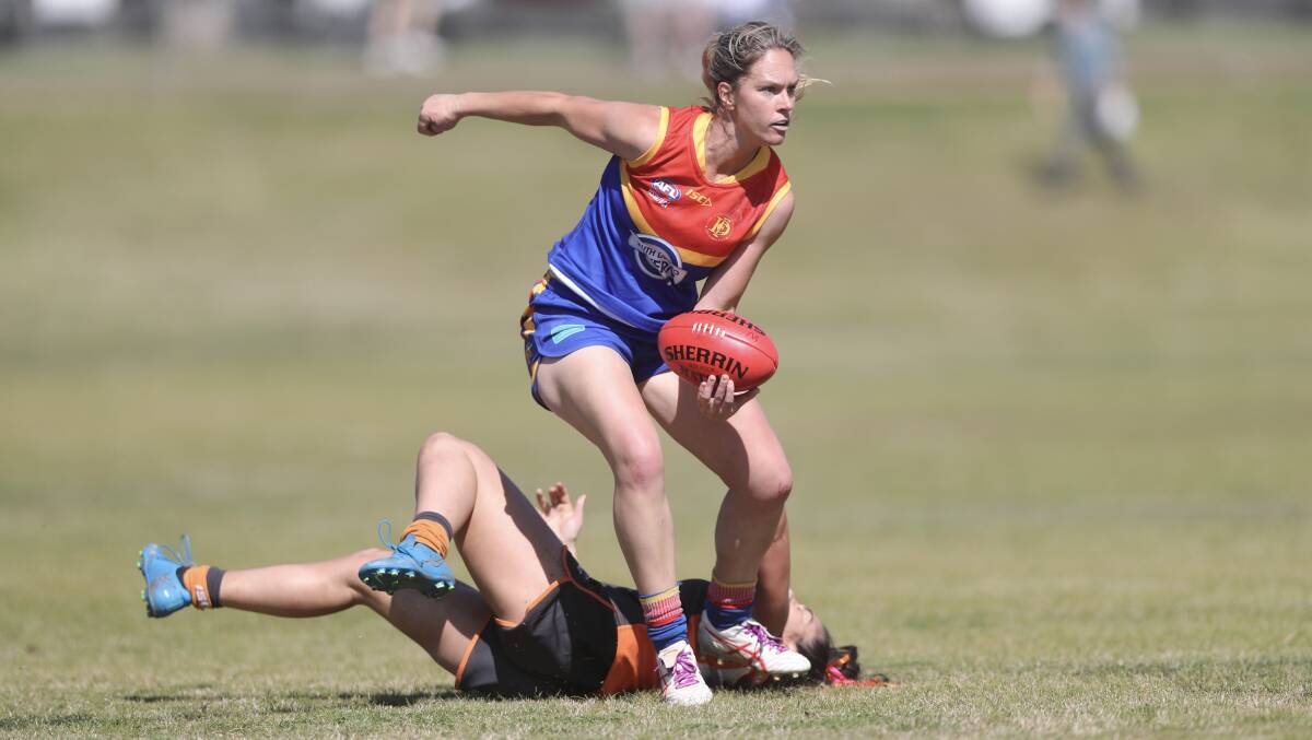 Emily Warner leaves a Giants player in her wake during the Demons' 2023 grand final win. Picture by Phil Blatch