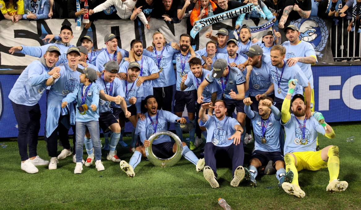 WINNING FEELING: Jacob Tratt (front row, third from right) and his Sydney FC teammates celebrate Sunday night's victory. Photo: AAP