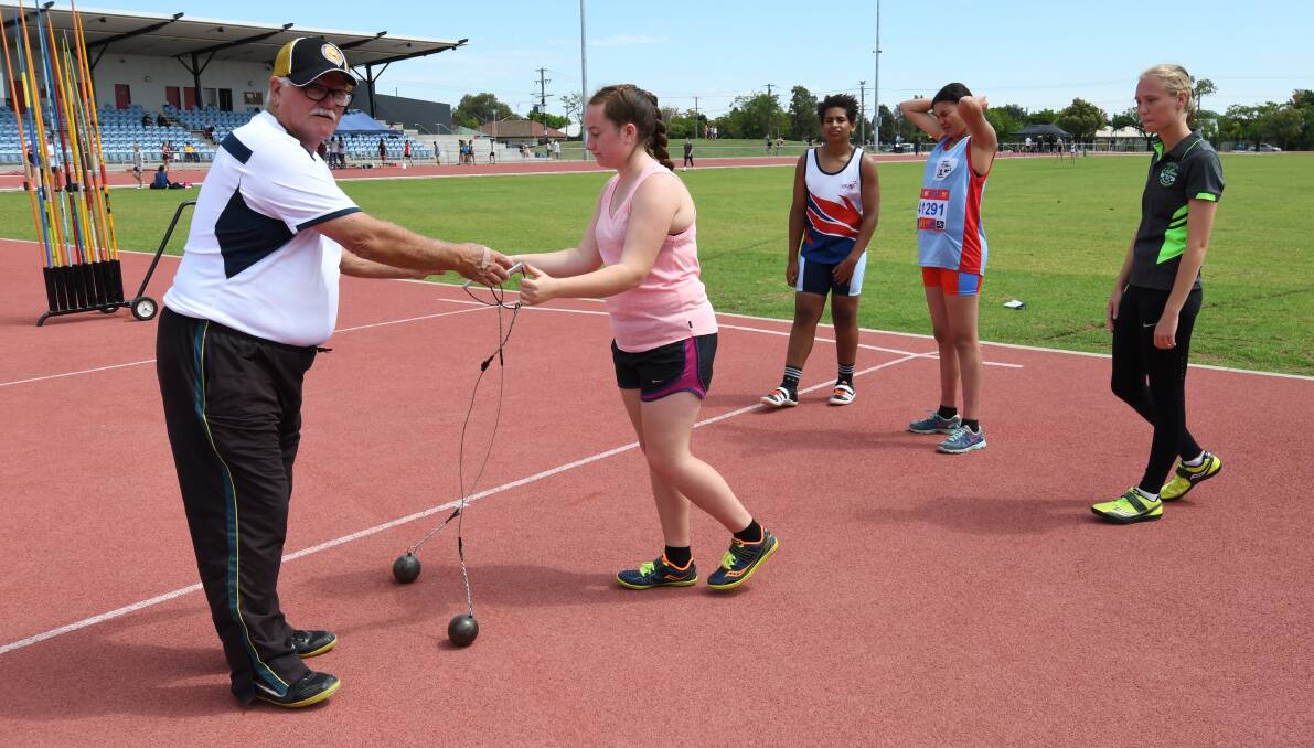 MASTER COACH: Ernie Shankelton with young athletes Sarah Williamson, Nosa Obaseki, Mea-May Stanbury and Eloise Bell during a hammer throw lesson.