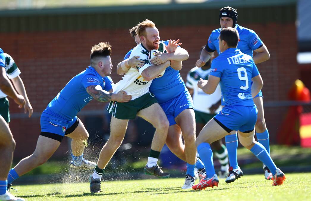 WRAPPED UP: Gulgong Terrier Brad James is met by the Italian defence while playing for the Western Rams on Saturday. Photo: PHIL BLATCH