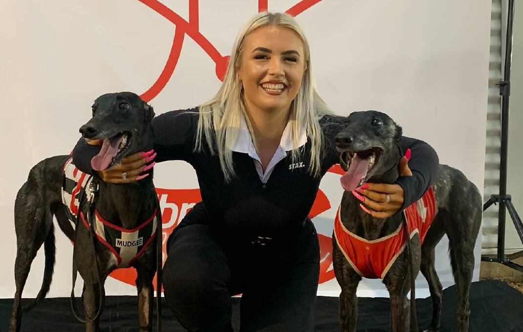 INTO THE FINAL: April Mackay, handler for trainer Jason Mackay, with opening heat winner Fantastic Raven (right) and runner-up Explosive Venom at Dawson Park on Saturday. Picture: Dubbo Greyhounds