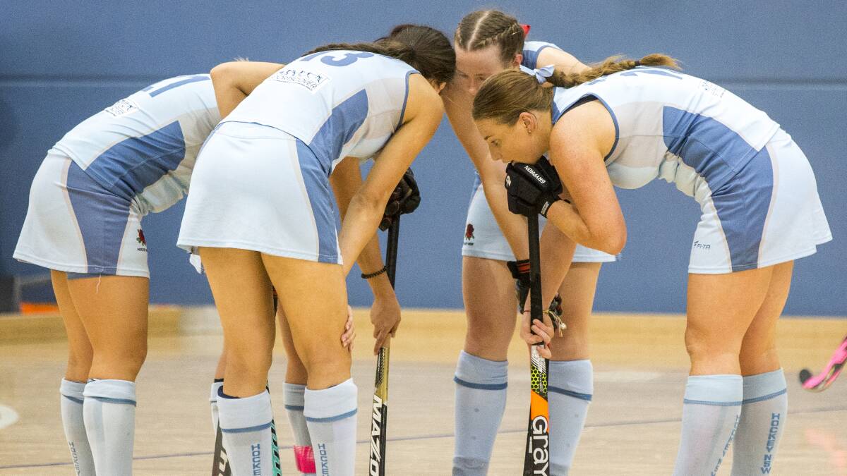 ALL TOGETHER NOW: The NSW players gather around and talk tactics during their winning start to the national under 21 titles. Photo: CLICK IN FOCUS