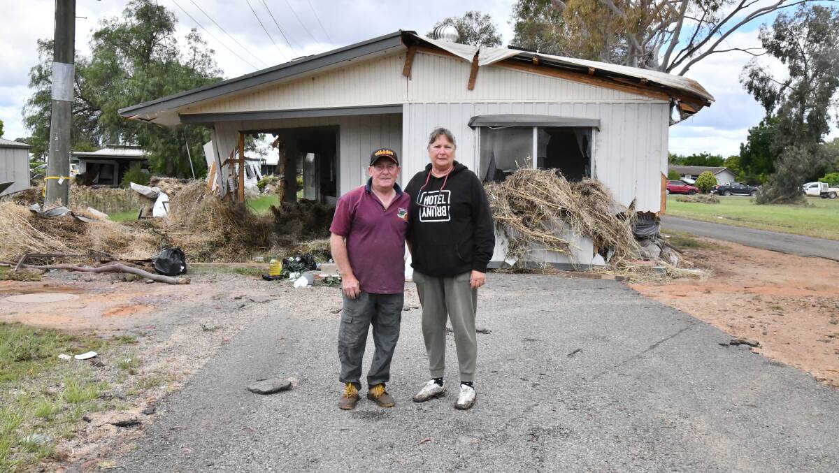George and Sue Cross standing at Eugowra in front of a house that floated down street to where it is and nearly hit them. Picture by Carla Freedman.