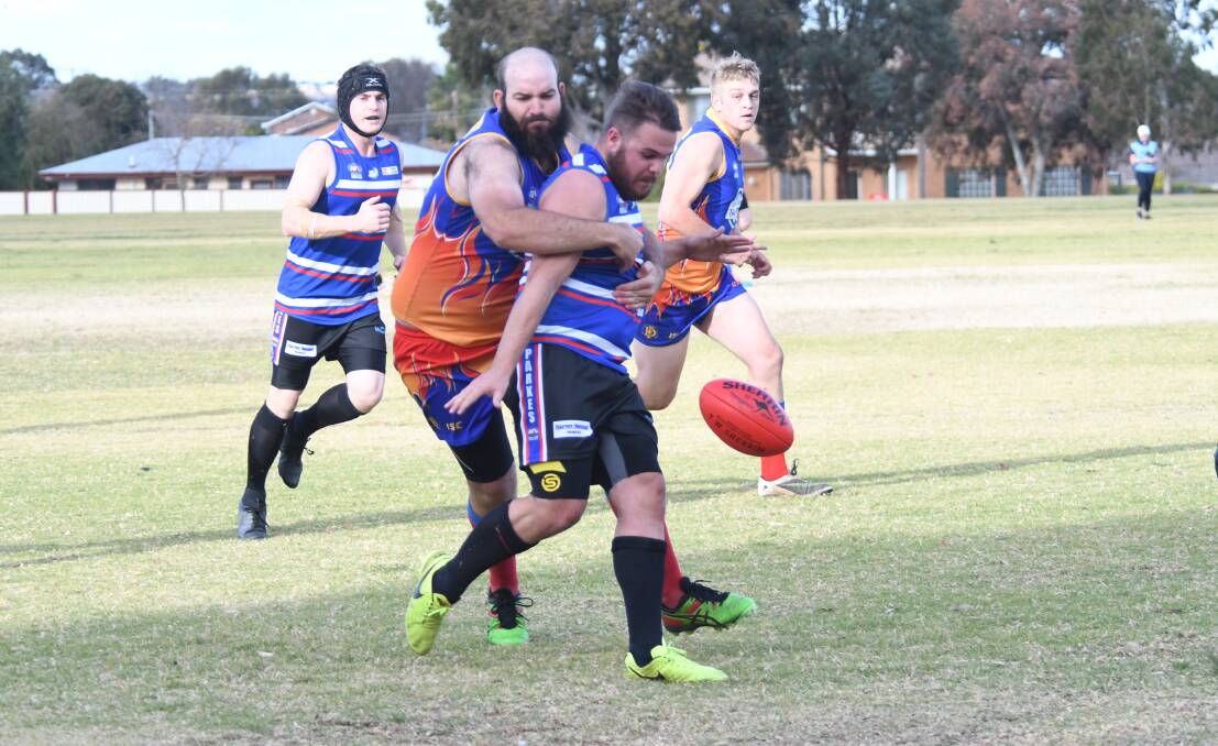 STRUGGLE: Dubbo's Tom Skinner tackles a Parkes player during a recent clash between the two sides. Photo: AMY McINTYRE