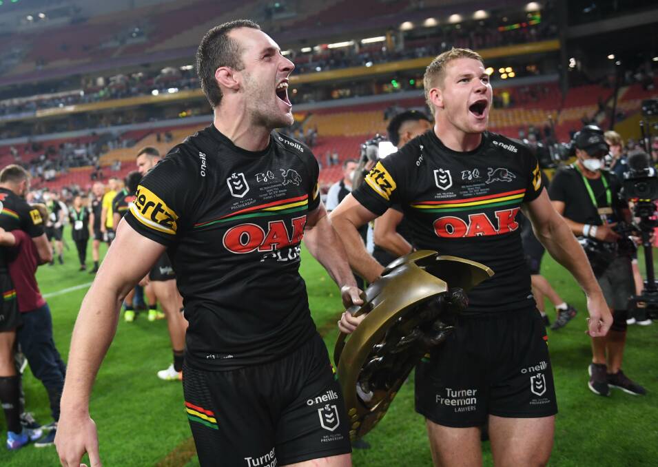 WEST IS BEST: Dubbo juniors Isaah Yeo (left) and Matt Burton celebrate with the NRL premiership trophy on Sunday night. Photo: NRL IMAGERY
