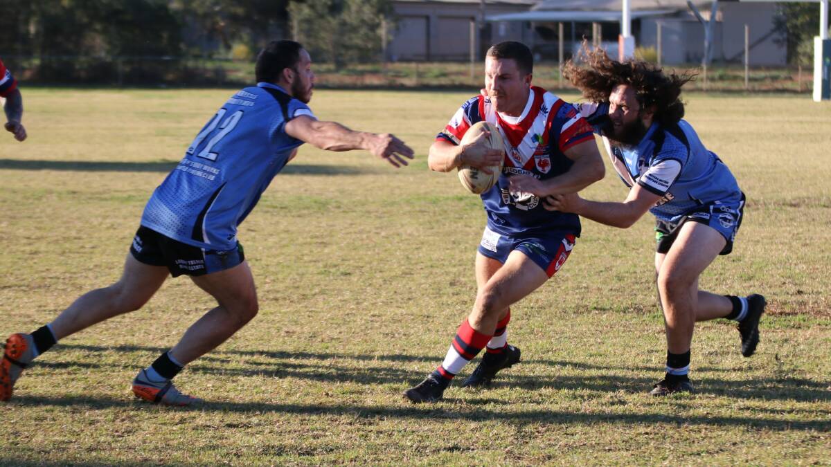 THREE'S COMPANY: Cobar hooker Jarred Whitty takes on the Bombshells defence en-route to a hat-trick. PHOTO: SHARON HARLAND.