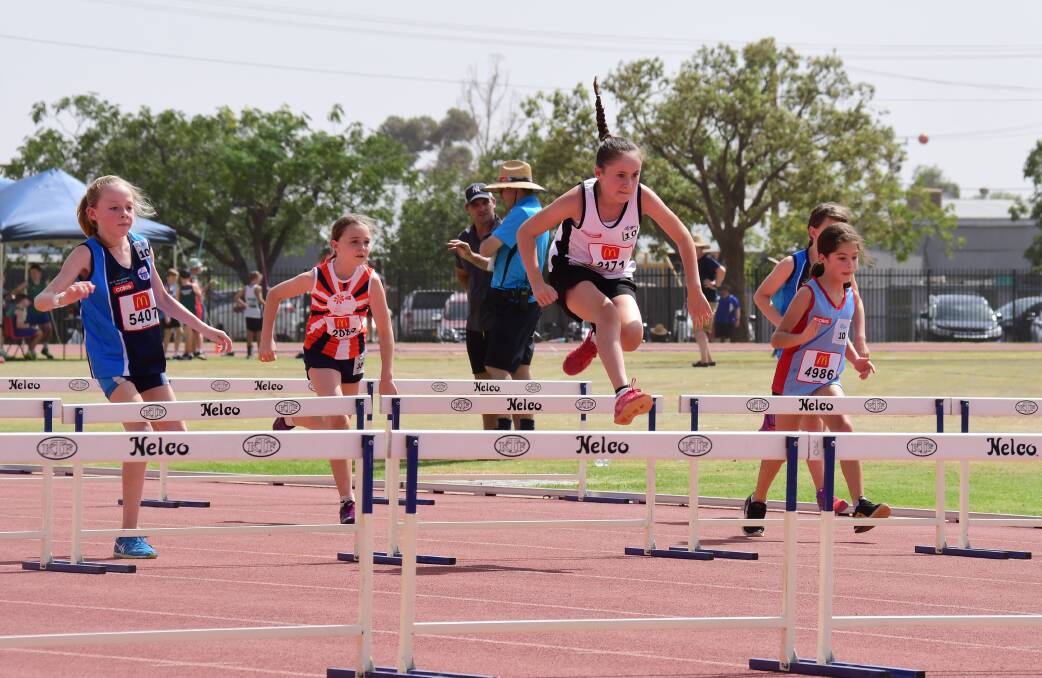 TAKE-OFF: Marli Pay flies over the hurdles during last year's Region 3 carnival at Barden Park. Photo: AMY McINTYRE