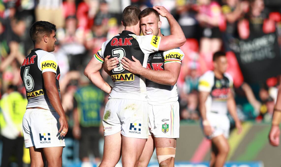 DUBBO DOUBLE: Kaide Ellis (right) is embraced by fellow Dubbo product Isaah Yeo after full time on Sunday. Ellis made his debut and helped the Panthers to an emphatic win. Photo: PENRITH PANTHERS