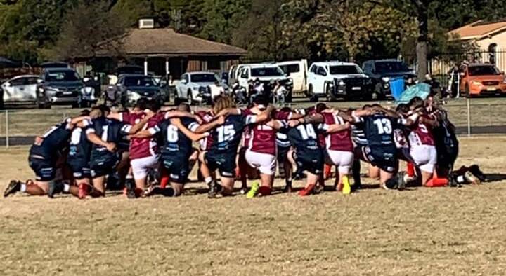 COMING TOGETHER: Players from the Wellington Cowboys and Macquarie Raiders took part in the #KneeForAckers prior to Sunday's Group 11 match. Photo: MACQUARIE RAIDERS FACEBOOK