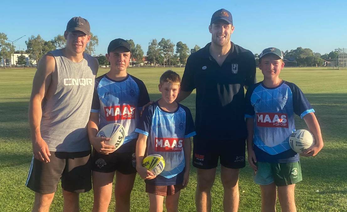 HAPPY HOMECOMING: Matt Burton (left) and Isaah Yeo with Dubbo District Junior Rugby League players during a visit late last year. Photo: CONTRIBUTED