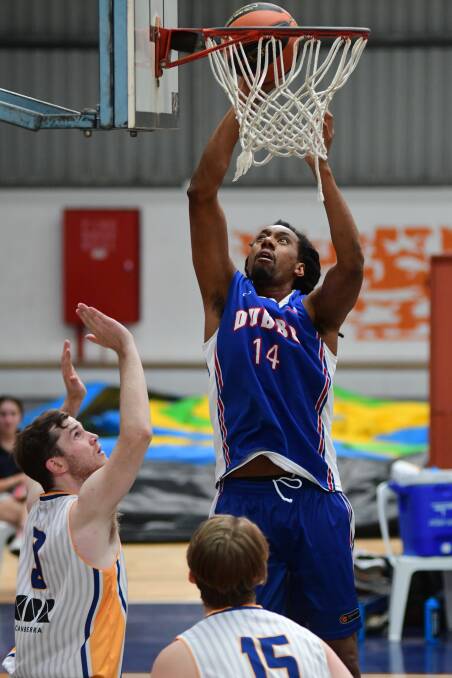 GET UP: Former Sydney Kings player Martin Iti delighted fans in round one when he slammed home a number of dunks for the Dubbo Rams. Photo: BELINDA SOOLE