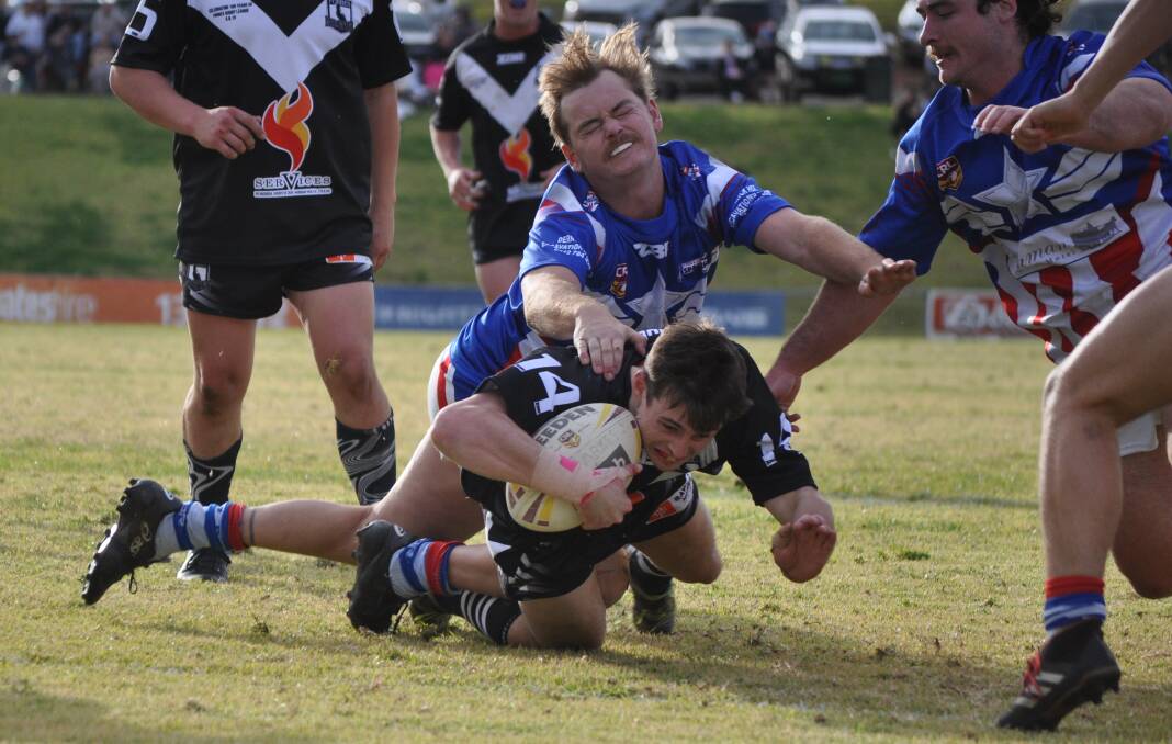 GET THERE: Jaiden Burke dives across to score a try for the Forbes Magpies in last year's long weekend derby clash with Parkes. Photo: NICK McGRATH